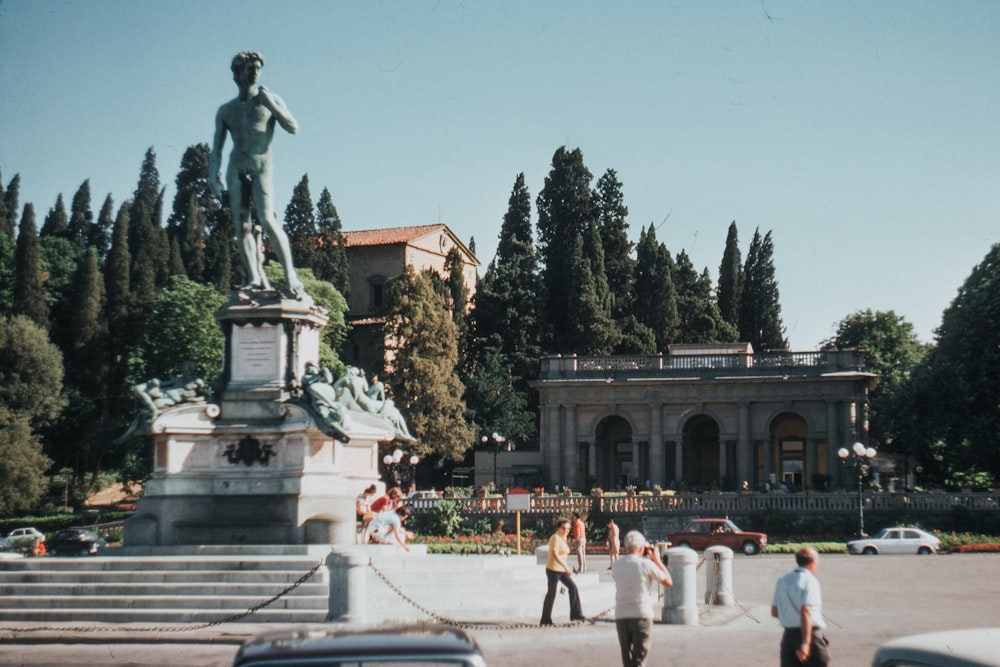 people standing near statue