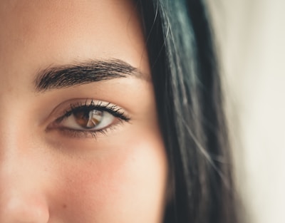 Close-up of a model's eye showcasing long, voluminous eyelashes with subtle, natural makeup.