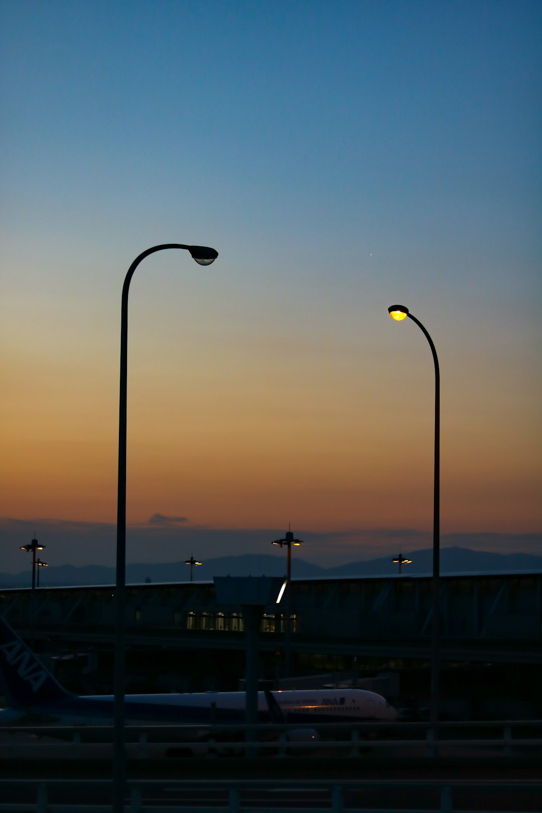 lighted outdoor lamp post near buildings