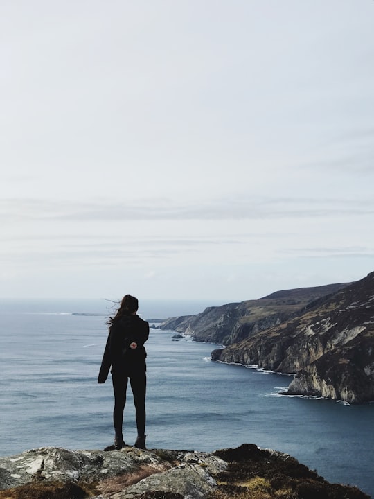 woman standing on cliff in Slieve League Ireland