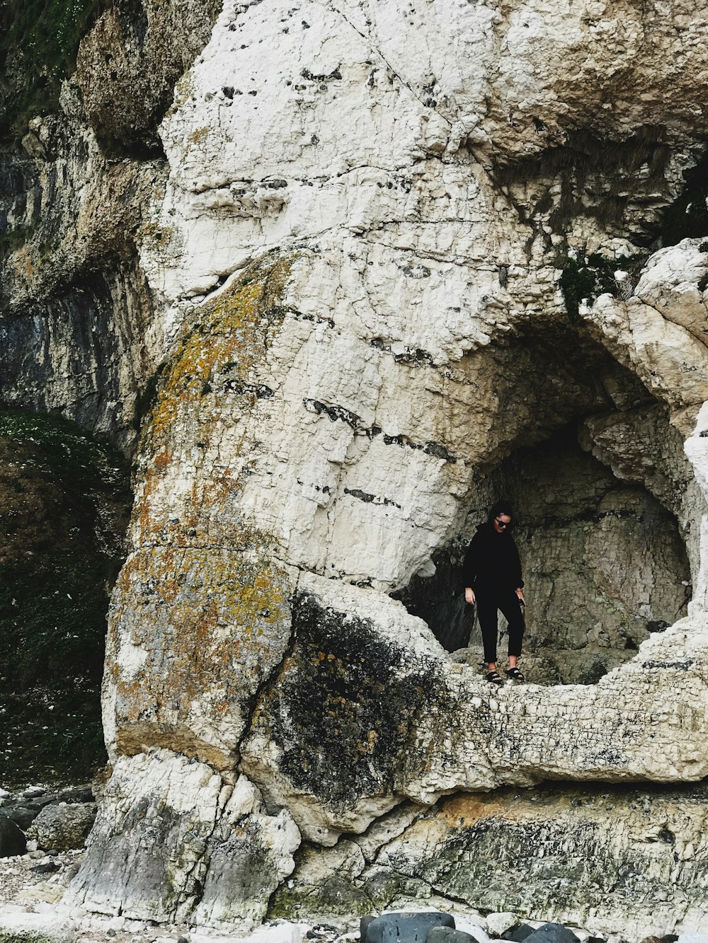 woman standing on rock mountain