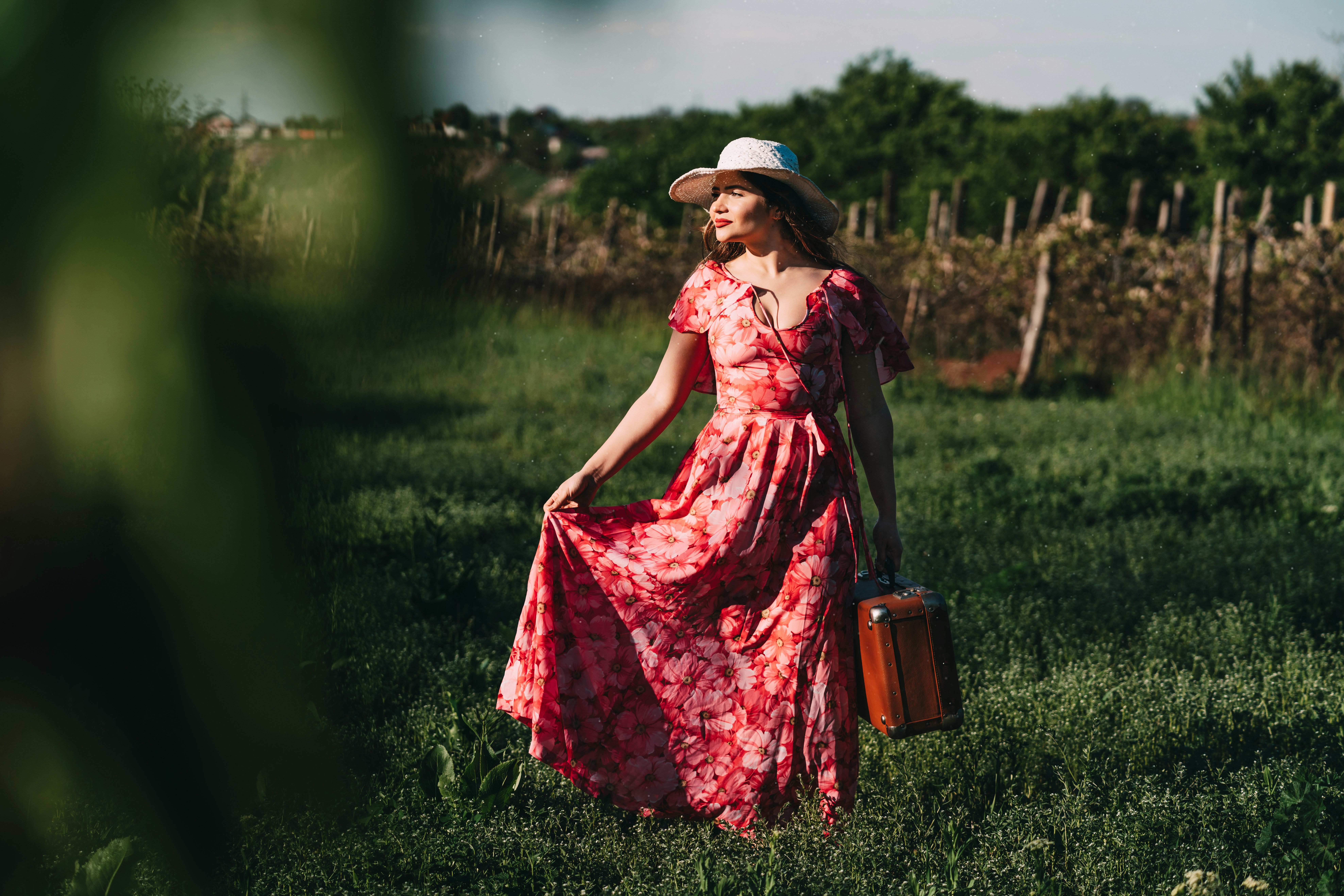 woman wearing red floral cap-sleeved maxi dress