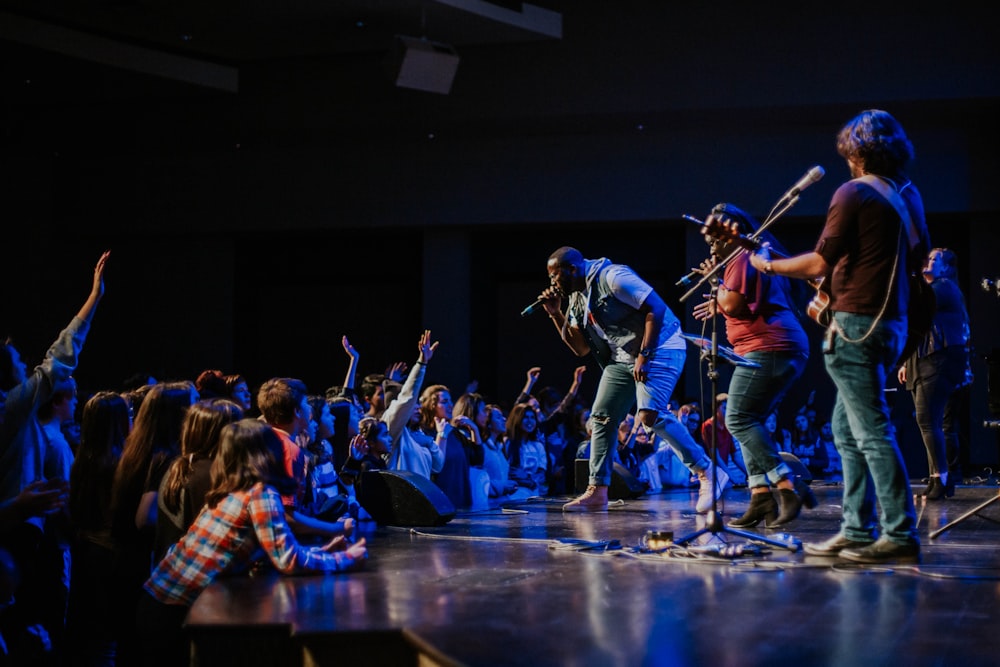 photography of singing man on stage