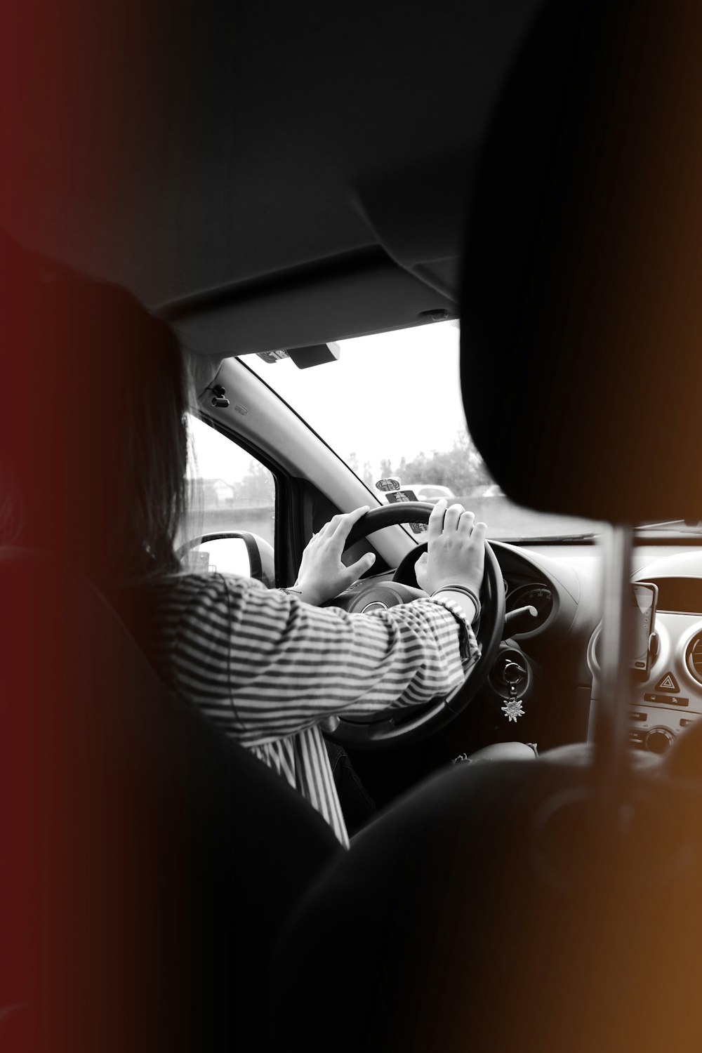 greyscale photography of woman inside vehicle