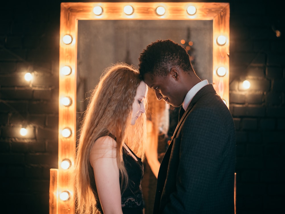 man and woman facing each other near mirror