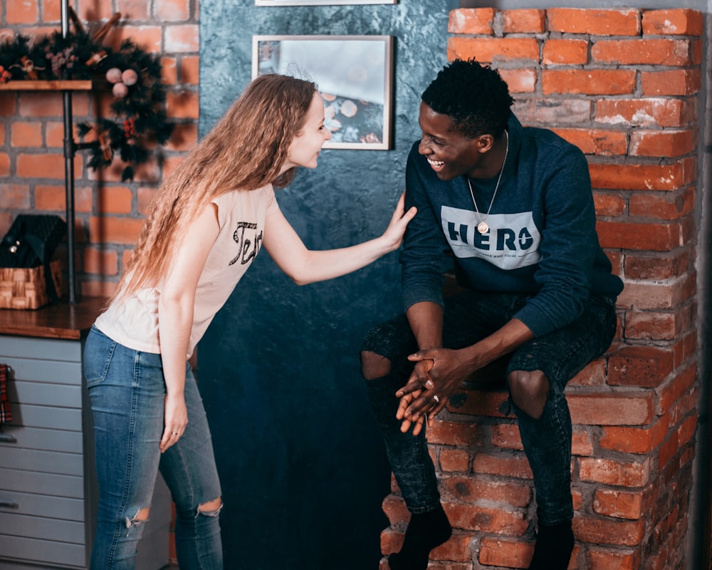 man and woman standing near wall