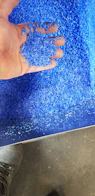 Close-up of colorful plastic granules in a container.