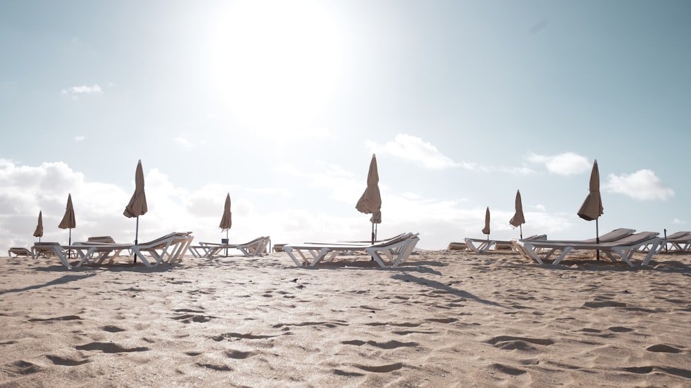 loungers on sand during daytime