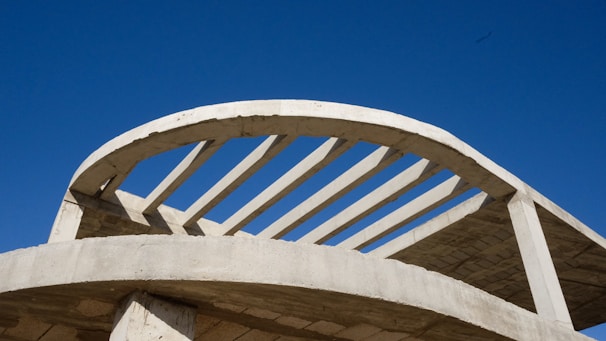 A partially framed house showing the skeleton structure against a clear blue sky.