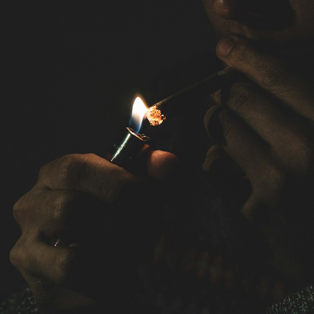 man lighting cigarette