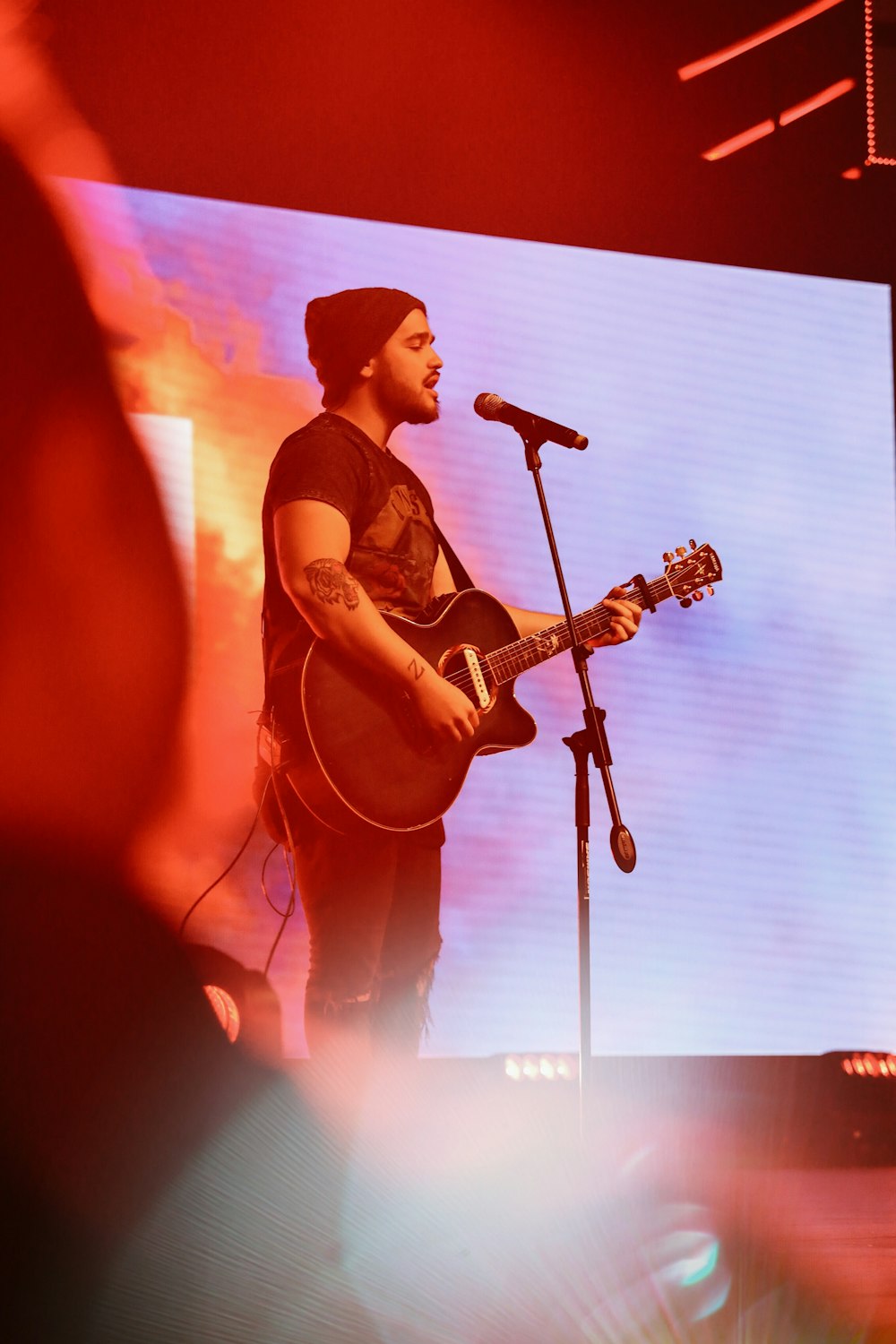 man singing playing guitar