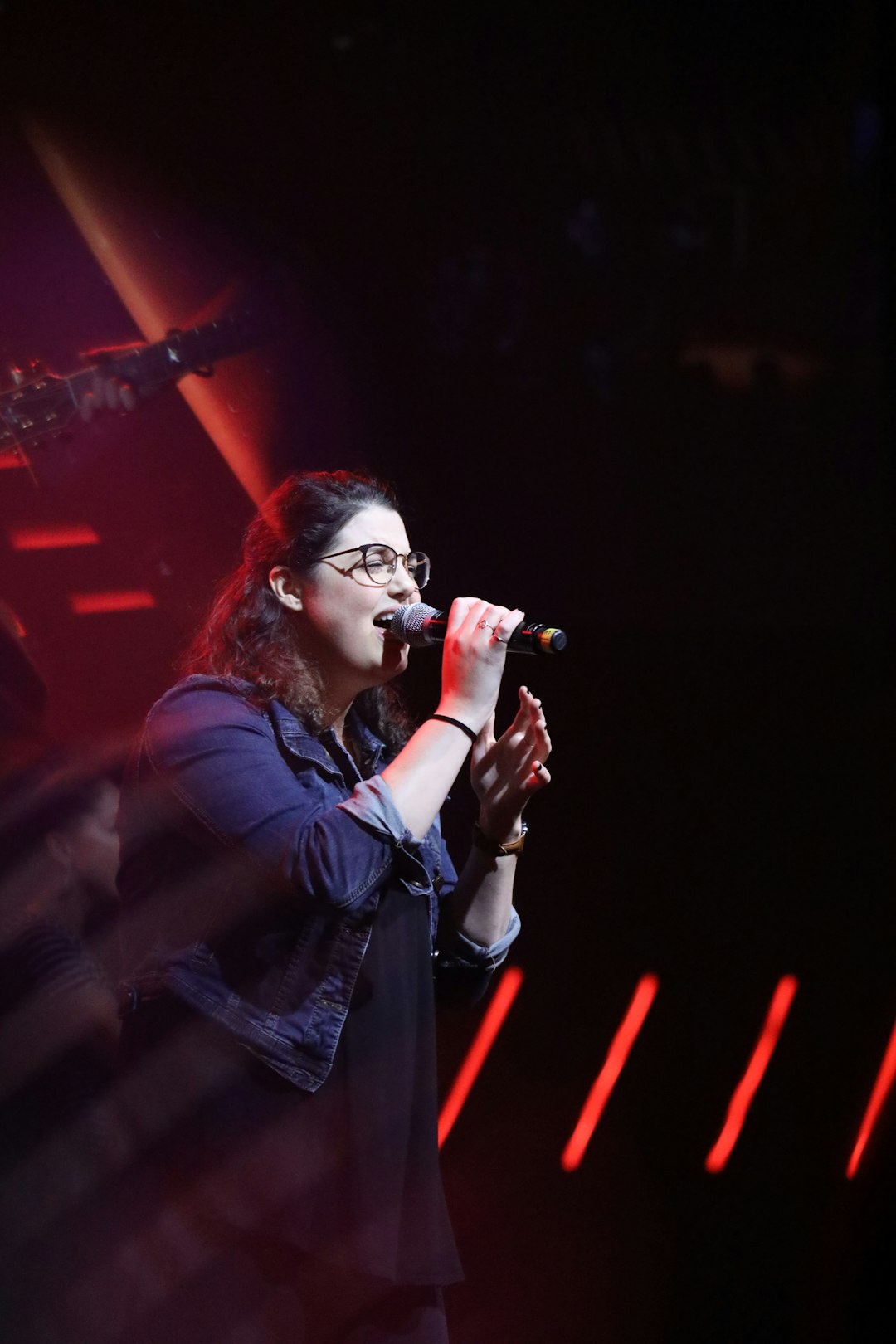 woman holding microphone singing
