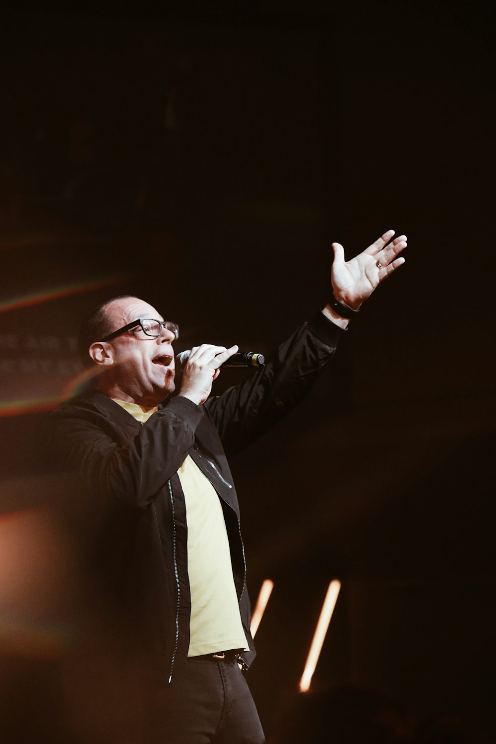 man in black jacket with microphone