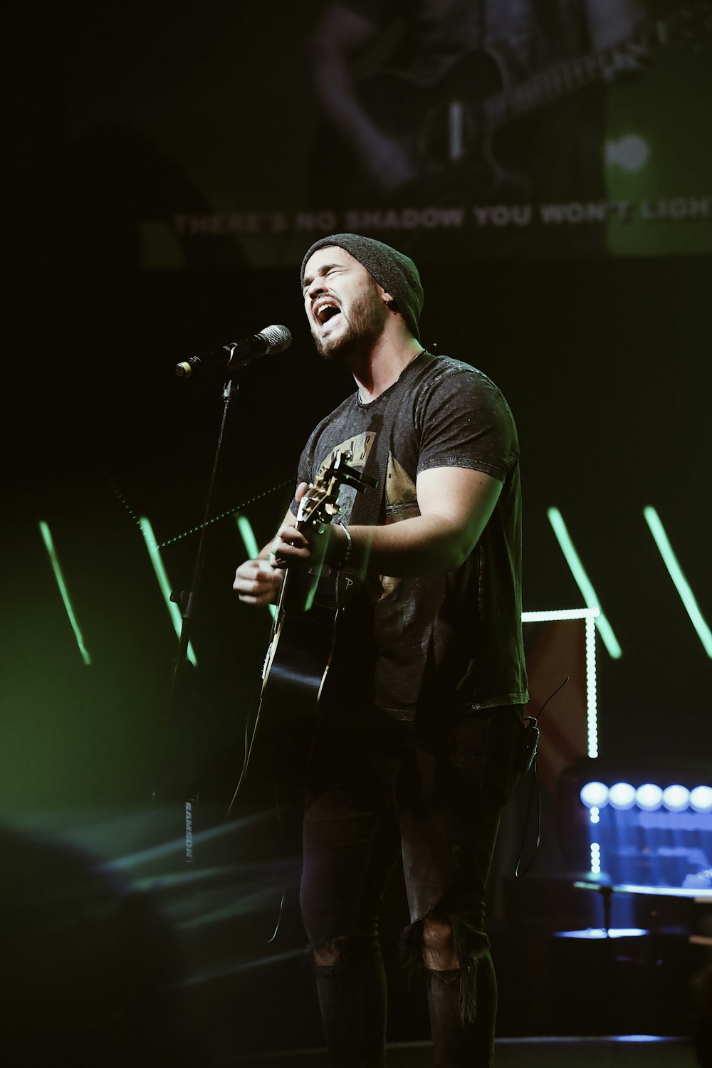 man playing guitar and singing