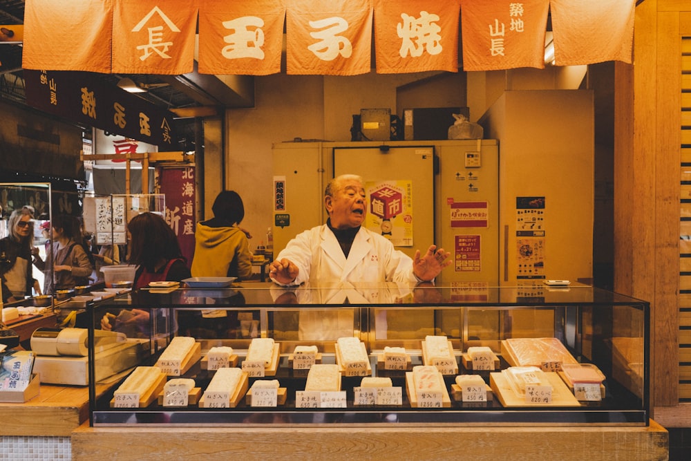 man standing near display counter