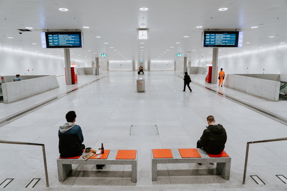 two men sitting on benches