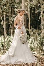 woman holding white flower bouquet during daytime