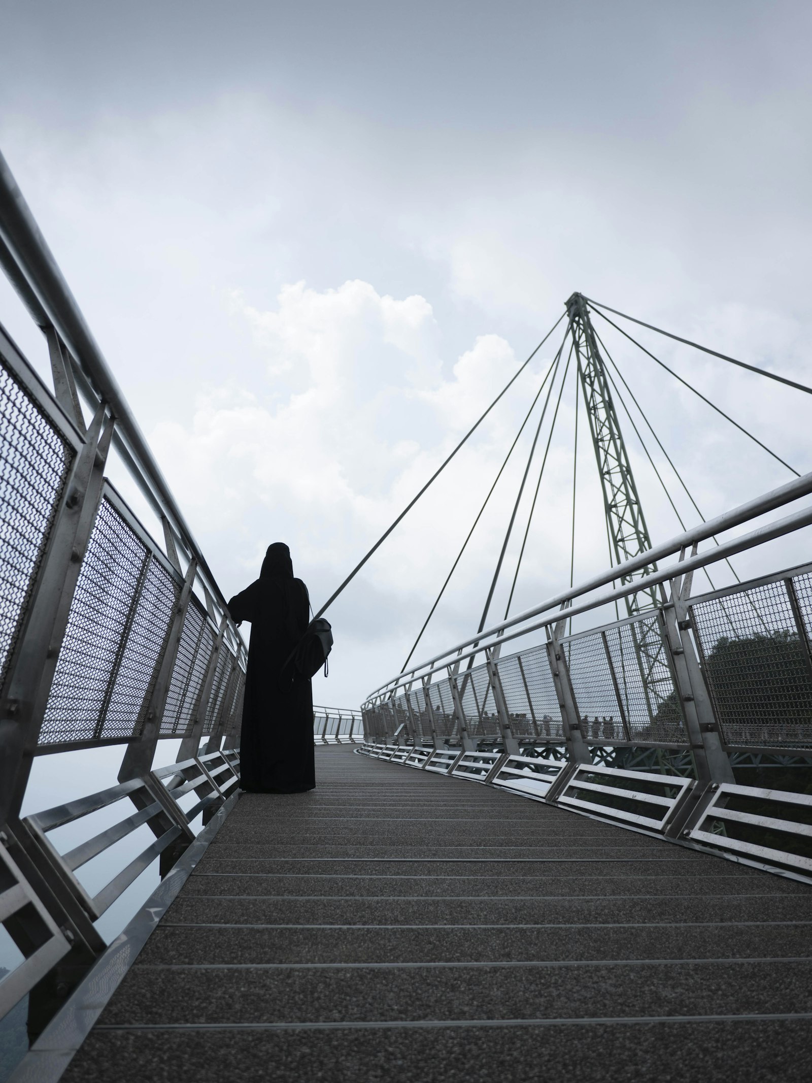 Panasonic Lumix G 14mm F2.5 ASPH sample photo. Person standing in bridge photography