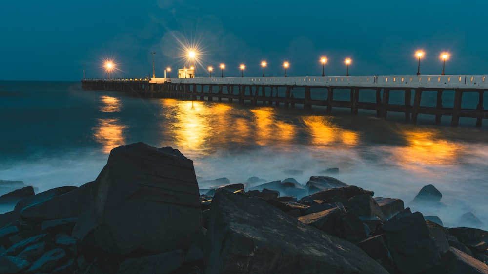 rocky shore and dock during night