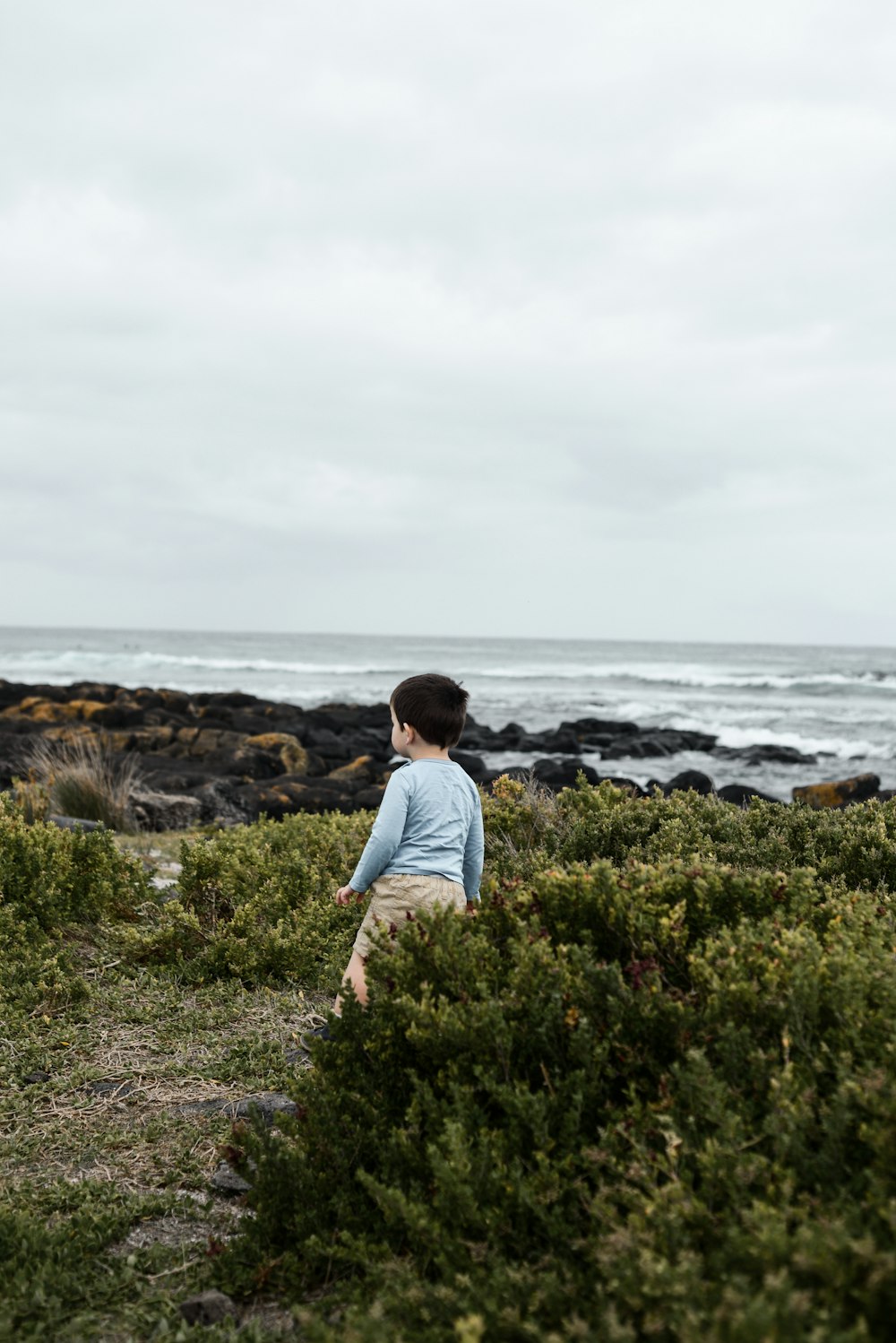boy standing near ocean