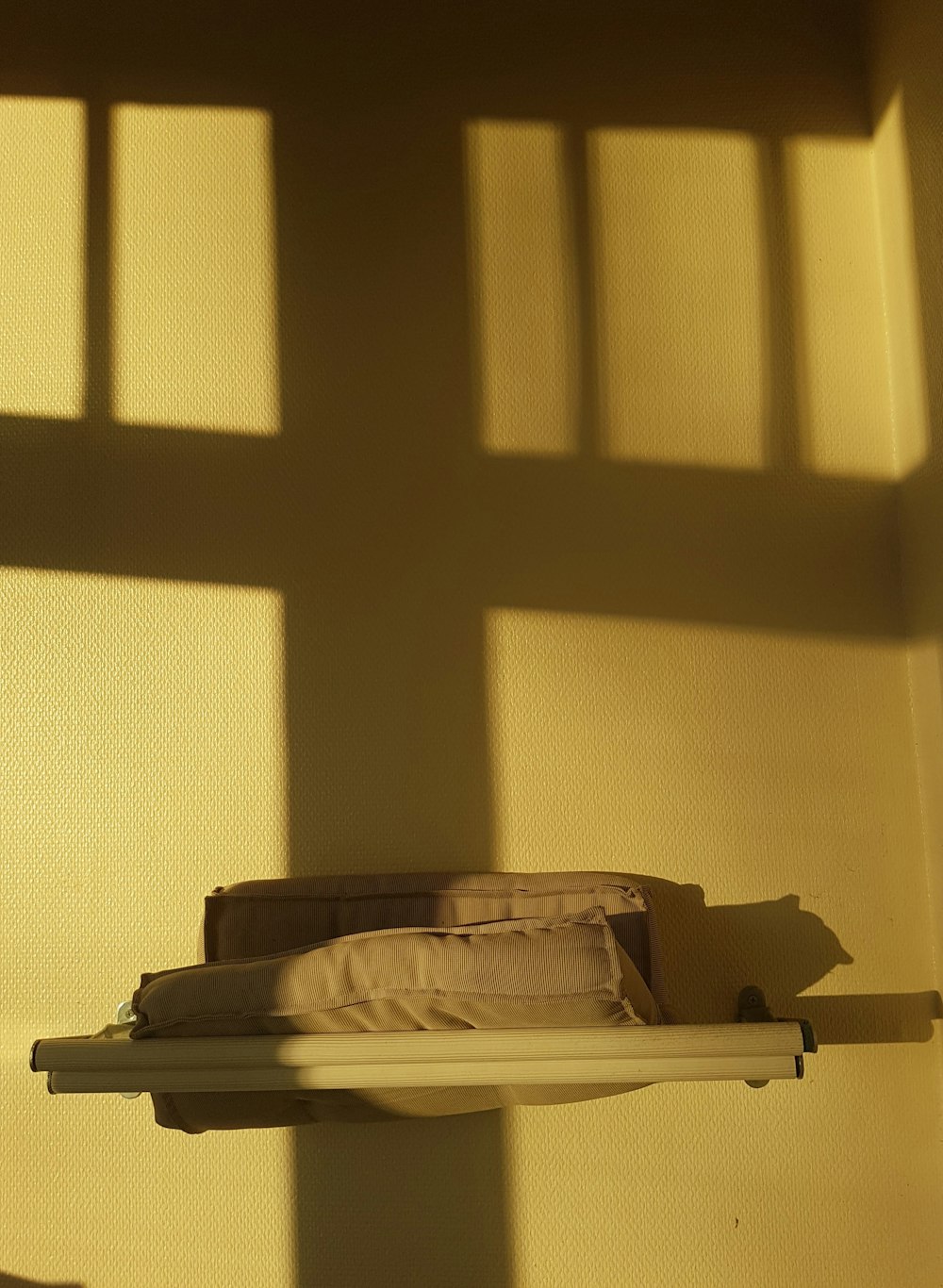 brown cushions on white wall shelf