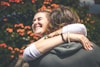 smiling woman hugging man
