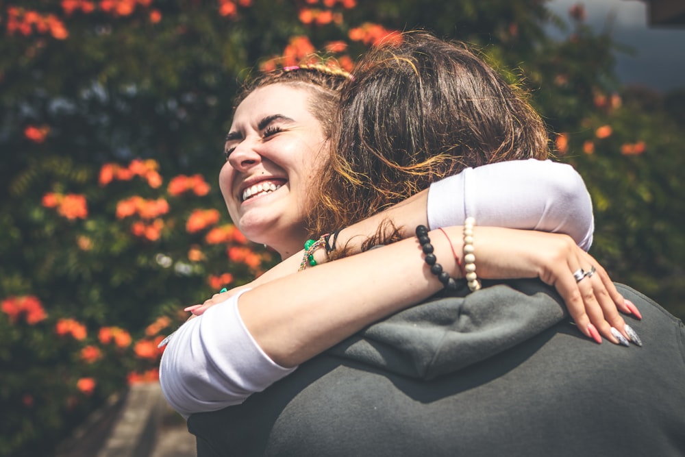 smiling woman hugging man