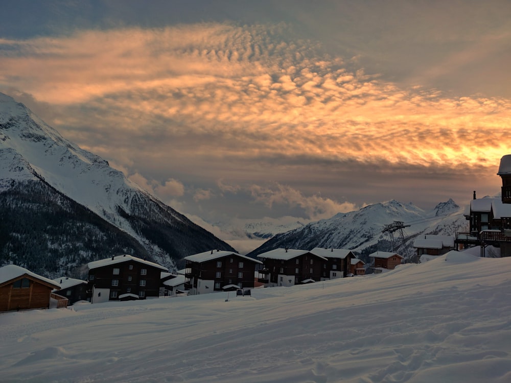 house covered with snow at sunset