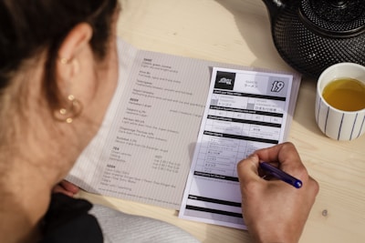woman writing on paper