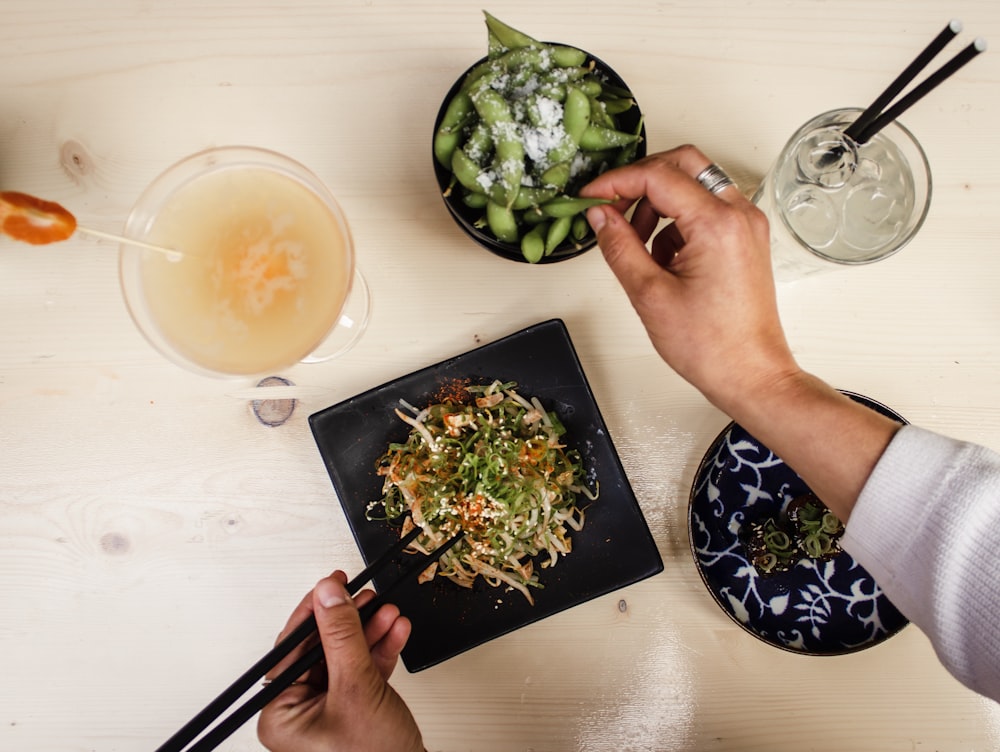 person eating using chopsticks