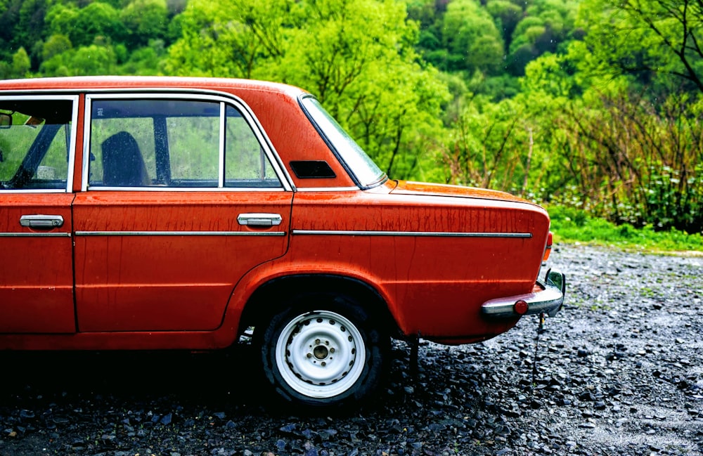 red sedan parking near road