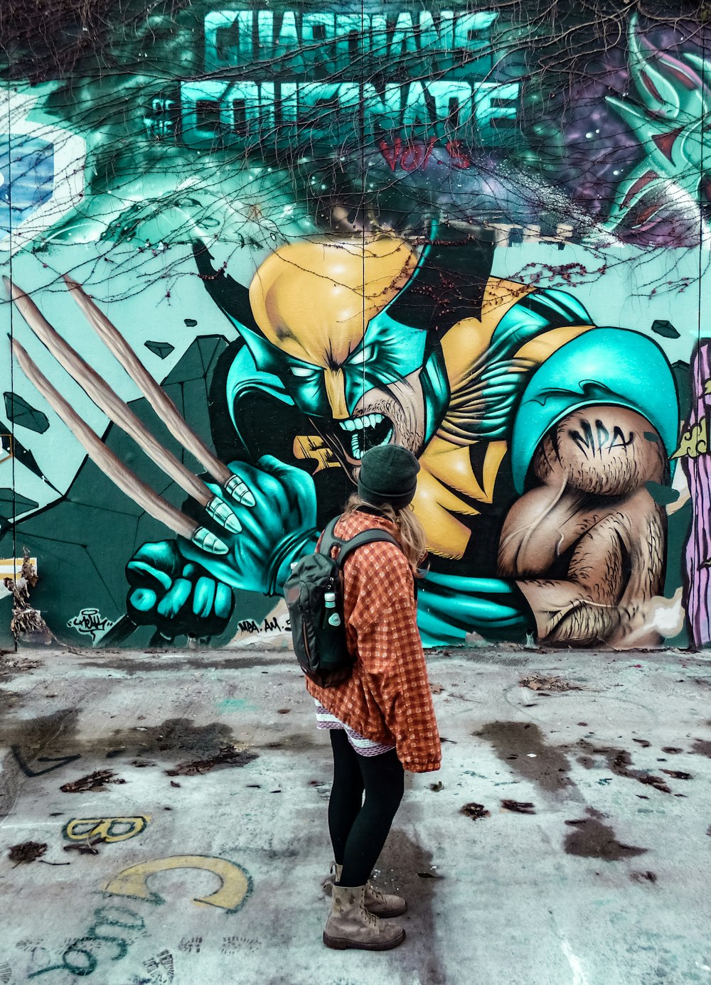 person standing near a wall painting during daytime