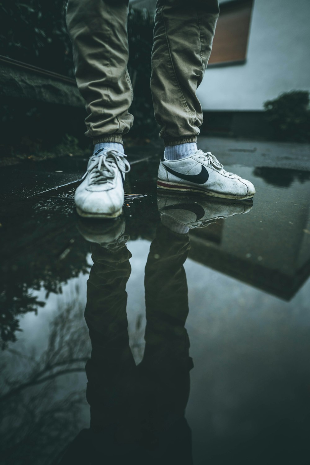 person in white Nike shoes on floor