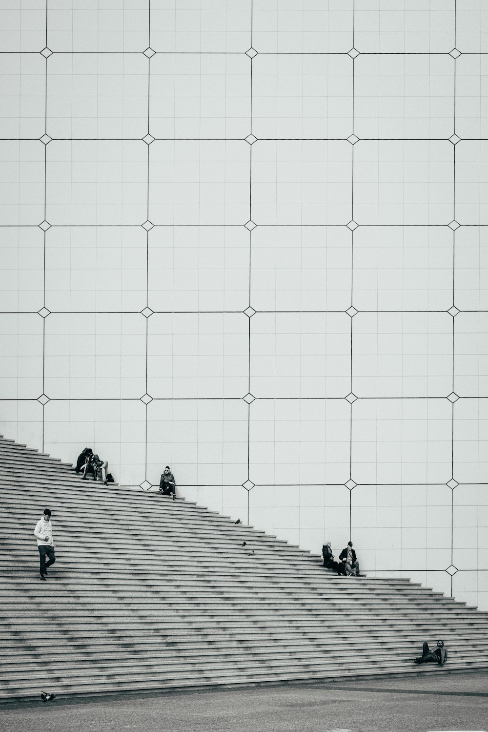 people in grey concrete stairs beside white building