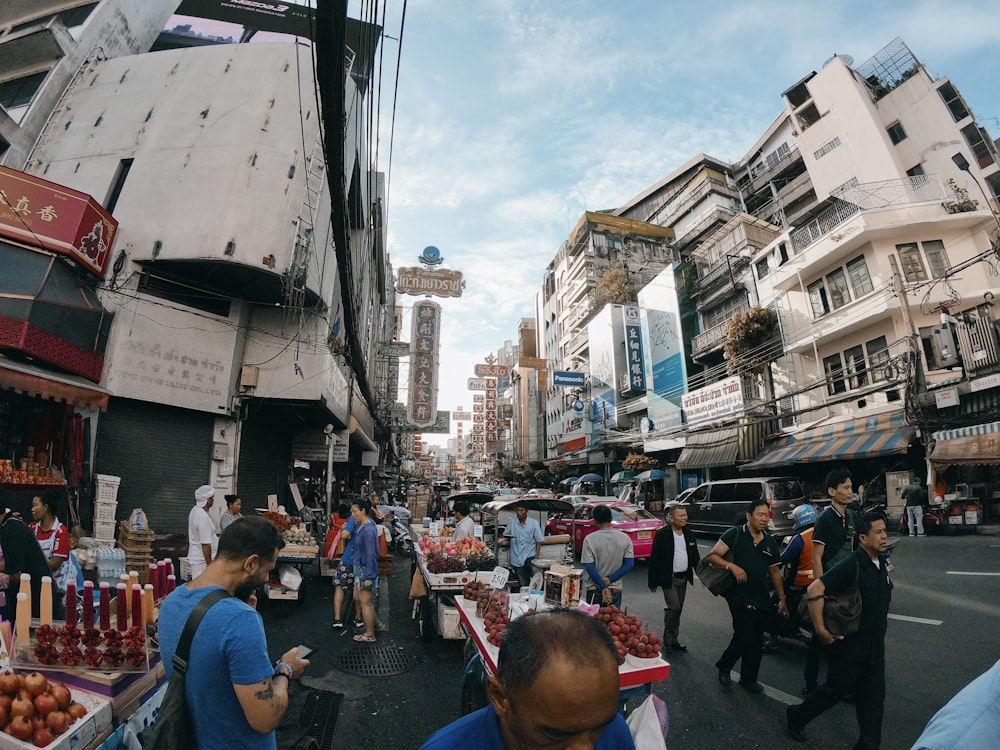 people in a road near buildings during daytime