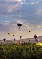 A scenic view of the flying field with colorful planes in the air.