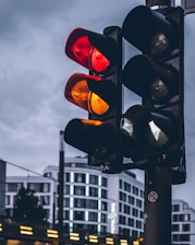 Close-up of a bright LED traffic light installed on a city street during sunset.