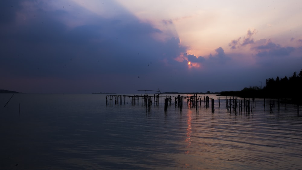 dock under cloudy sky during daytime