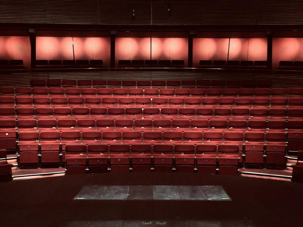 vacant red cinema chairs