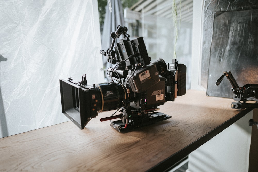 black video camera on wooden surface