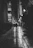 A silhouette of a woman walking along a moonlit Paris street, wearing a flowing velvet coat.