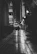 A silhouette of a woman walking along a moonlit Paris street, wearing a flowing velvet coat.