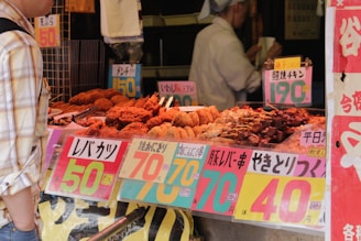 assorted foods displayed in booth near people