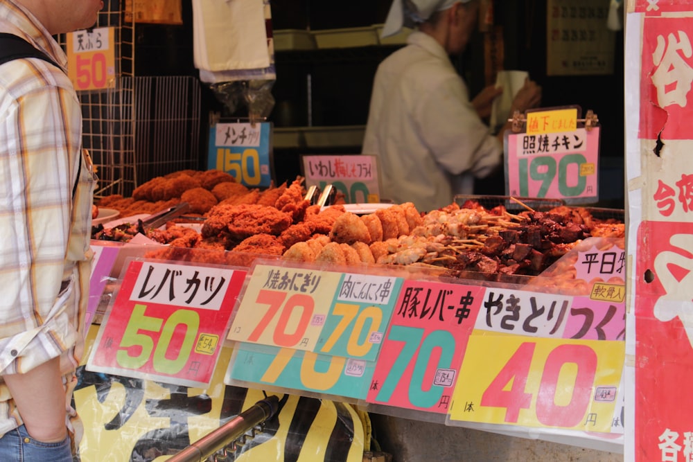 assorted foods displayed in booth near people