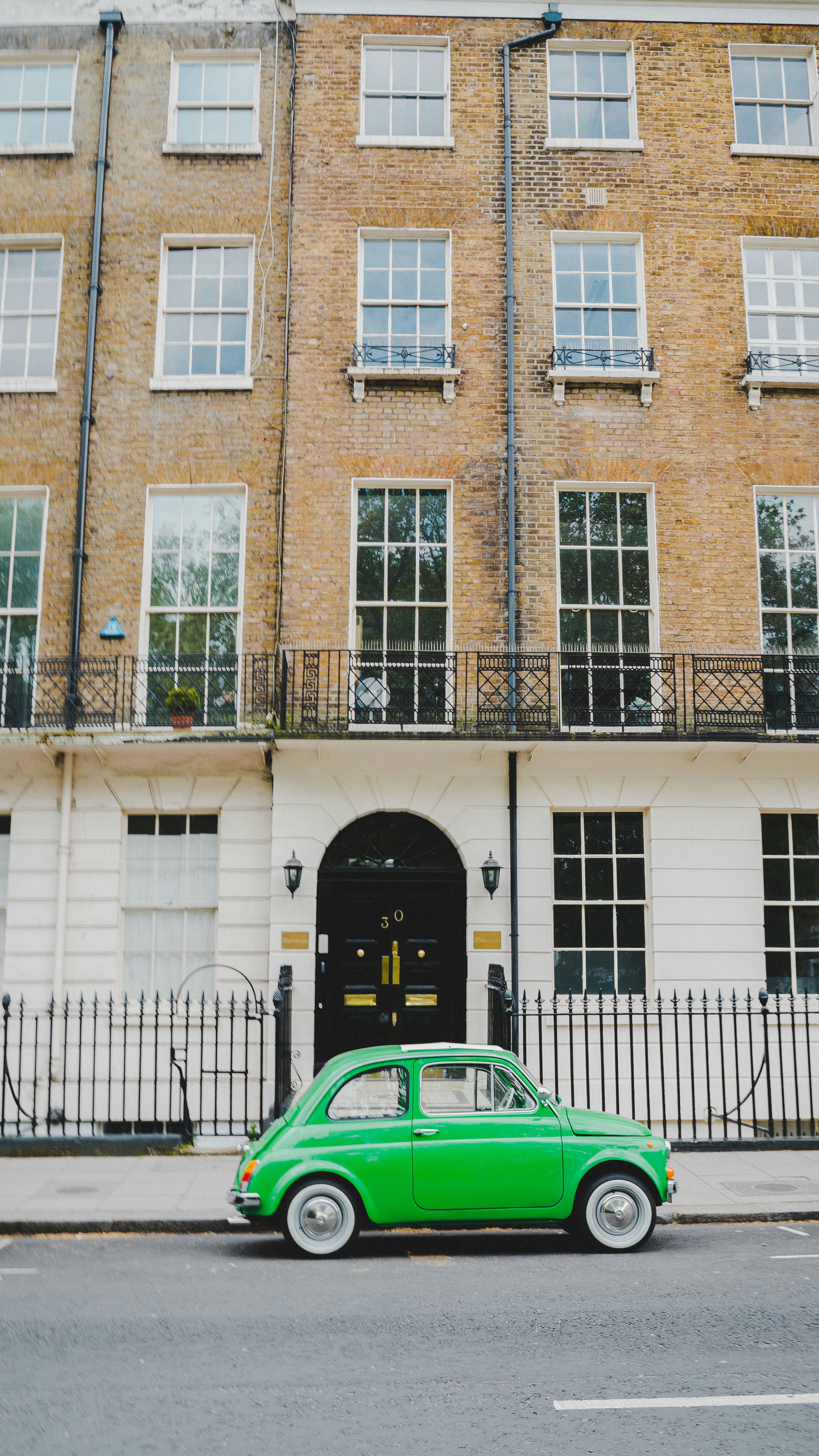 green vehicle near building