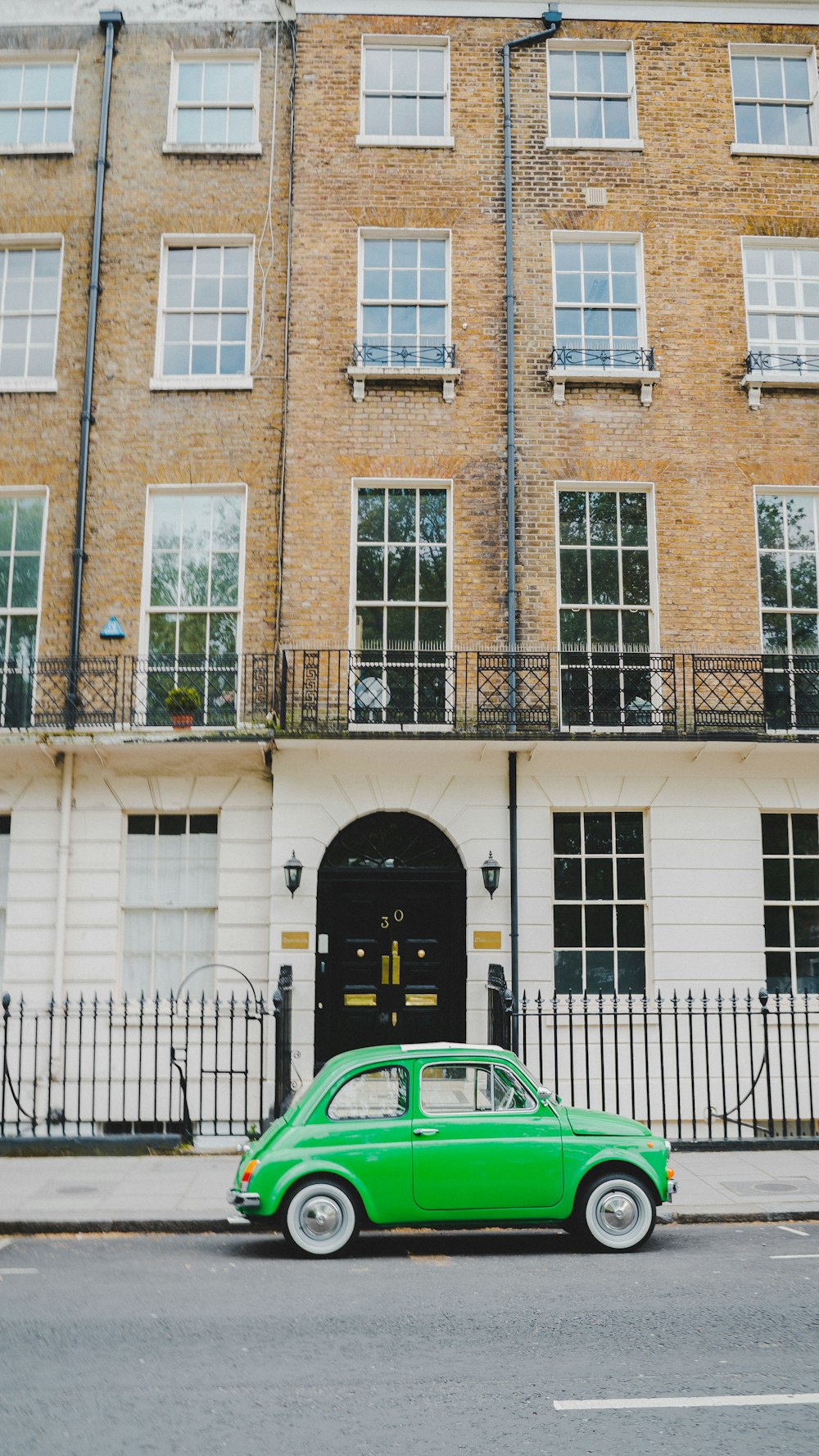 green vehicle near building