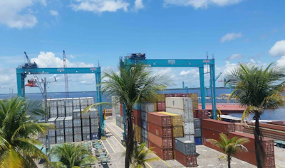Detailed photo of cranes loading containers at Panama's port with vivid colors
