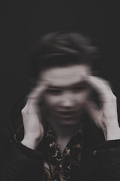 men holding his head grey-scale photography