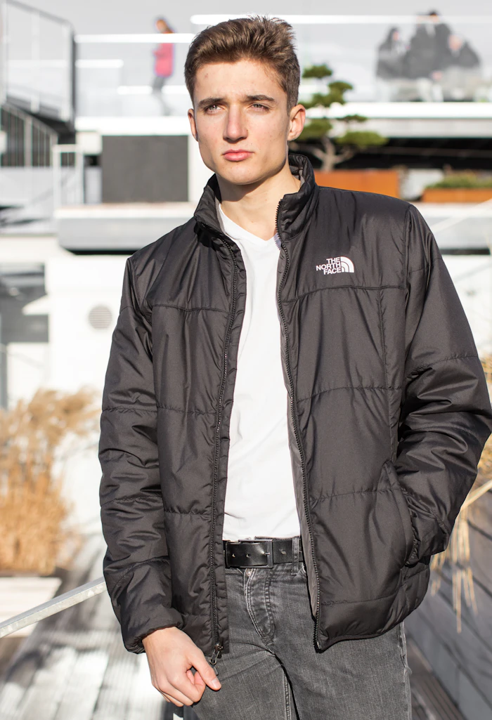 Young man in a black padded jacket outdoors