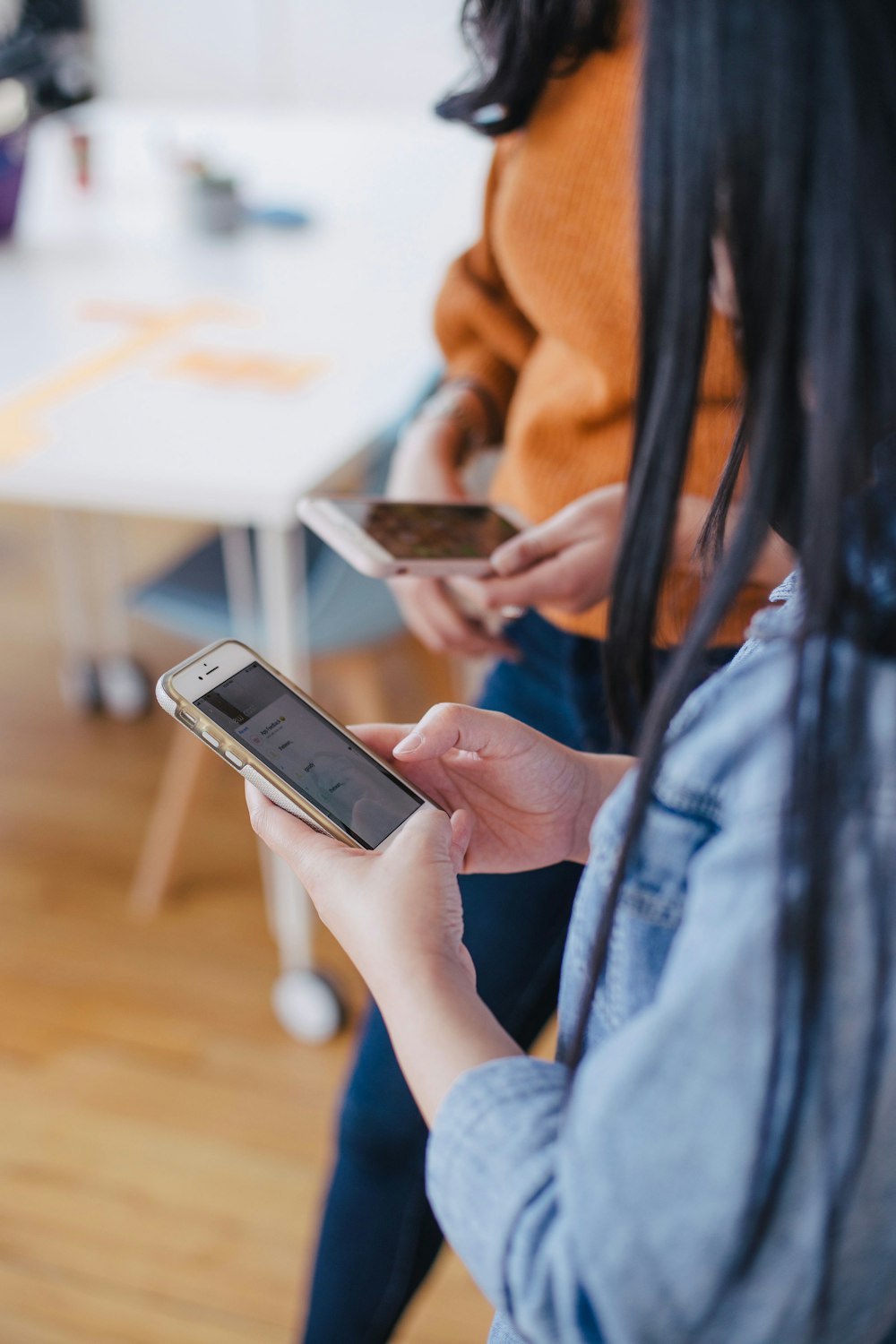 selective focus photography of woman holding phone